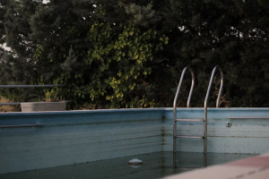 A drained pool with worn walls