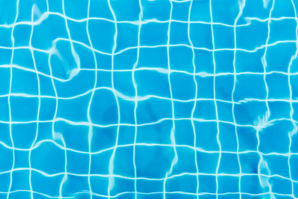 Close-up image of pool tiles under water.