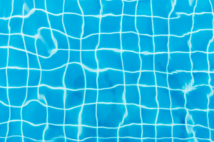 Close-up image of pool tiles under water.